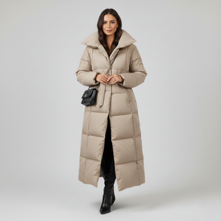 Woman wearing a long beige puffer coat on a white background