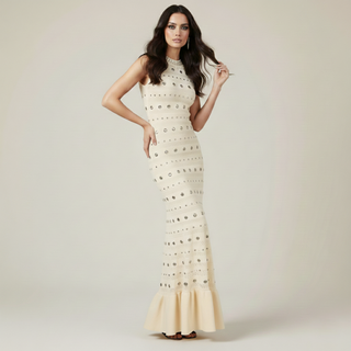 Woman wearing a white lace dress on a plain background