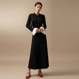 Woman wearing a black dress with white cuffs on a beige background