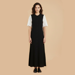 Woman wearing a black dress with white sleeves on a beige background