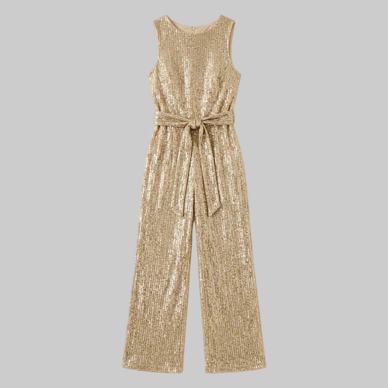 Gold sequin jumpsuit on a light beige background