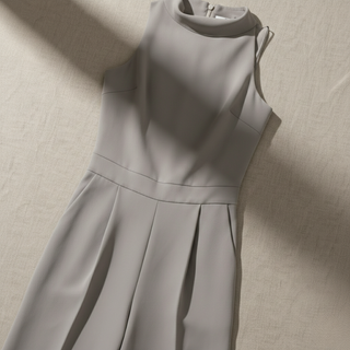 Gray sleeveless dress on a beige textured background