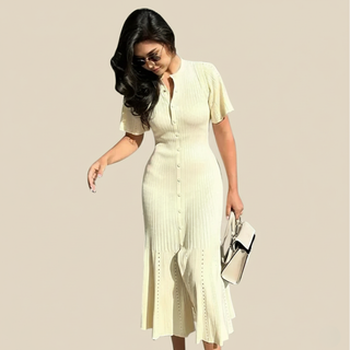 Woman wearing a light yellow dress against a beige background