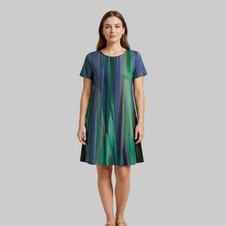 Woman wearing a green and purple striped dress on a beige background