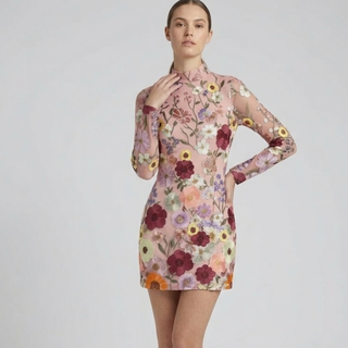 Woman wearing a floral dress on a plain background