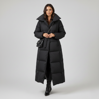 Woman wearing a long black puffer coat on a gray background