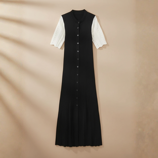 Black dress with white sleeves on a beige background