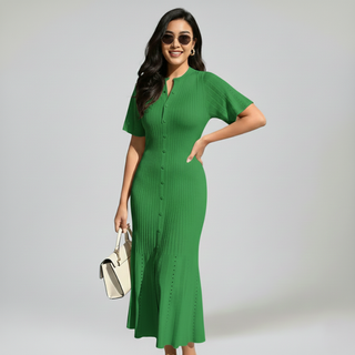 Woman wearing a green dress with a plain background