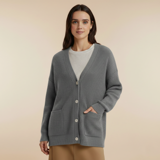 Woman wearing a gray cardigan on a beige background