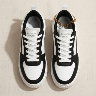Black and white sneakers with 'Fashion Sport' text on a beige background