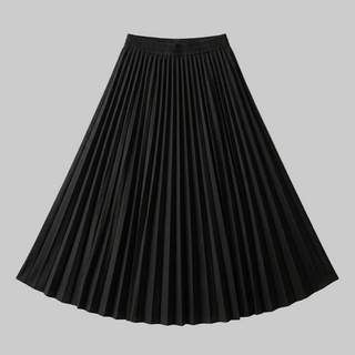 Black pleated skirt on a beige background