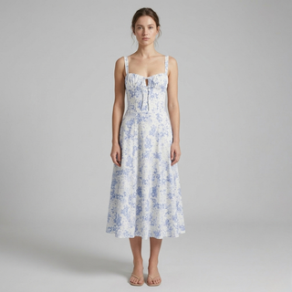 Woman wearing a floral dress on a plain background